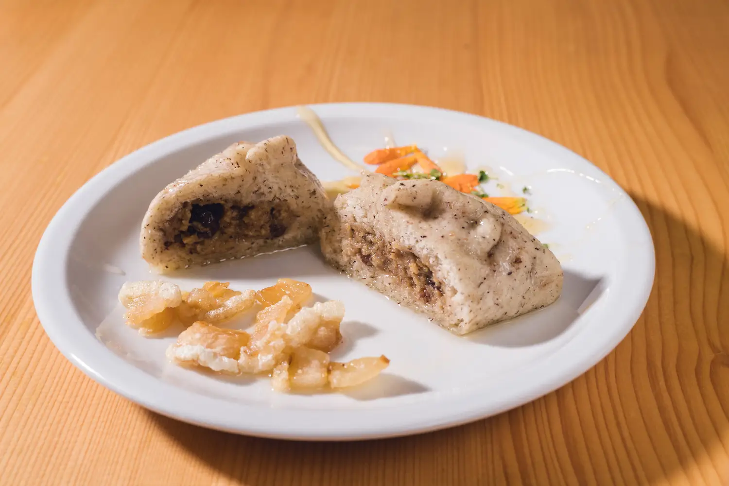 Traditional buckwheat štruklji stuffed with walnuts and drizzled with honey, a signature Slovenian dessert.
