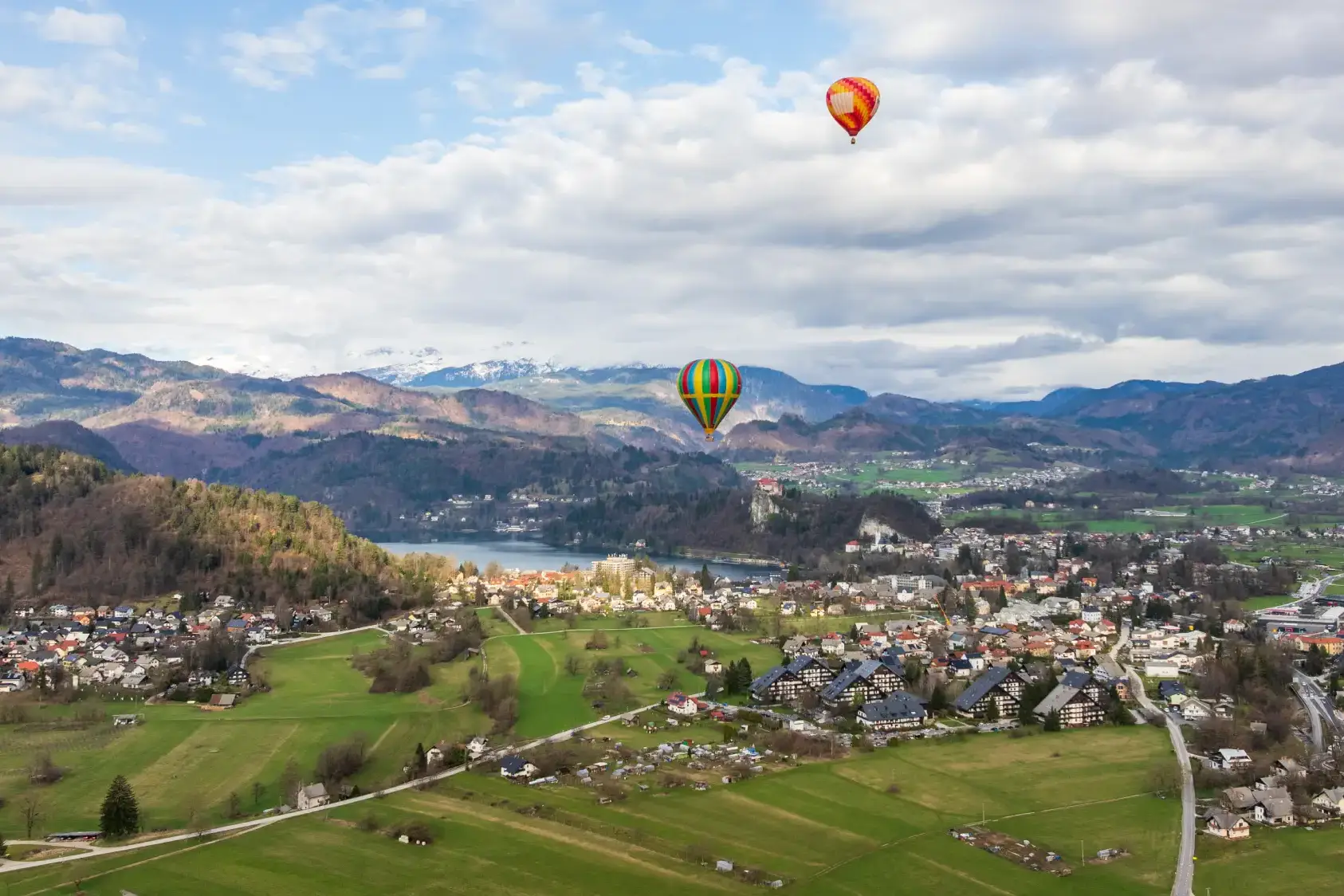 Hot-air balloons floating over Lake Bled and the Slovenian Alps during an exclusive incentive experience.