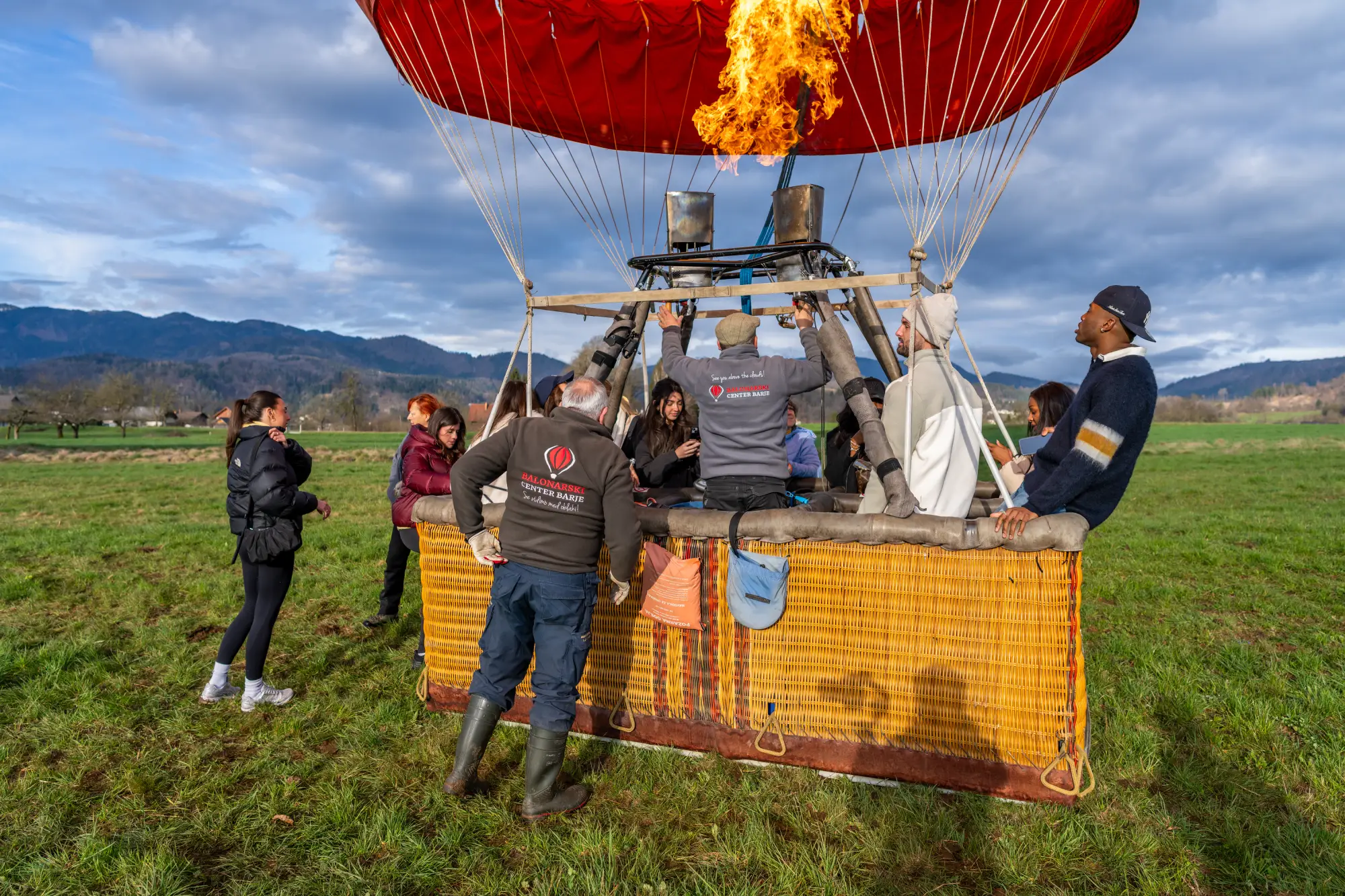 Corporate group preparing for a hot-air balloon experience in Slovenia with local ballooning experts.