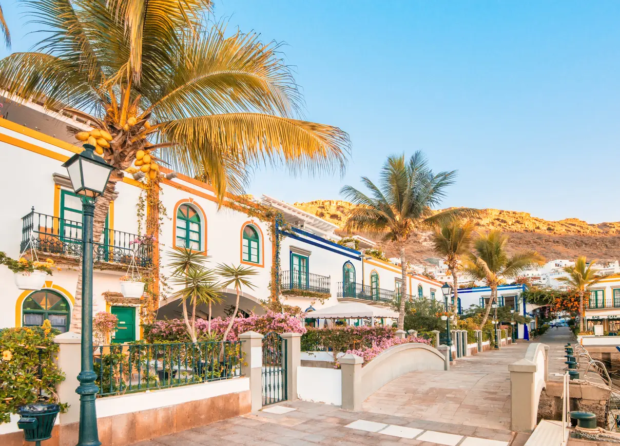 Slikovite hiše in palme ob promenadi v Puerto de Mogánu na otoku Gran Canaria.